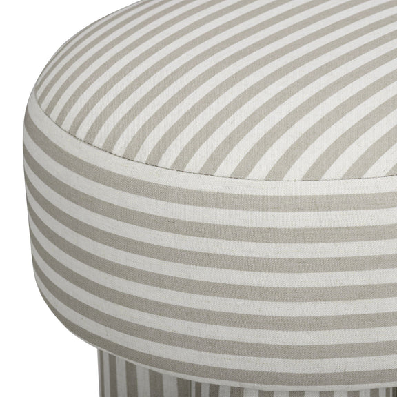 Gray and cream striped upholstered accent stool with close-up of round seat and side.