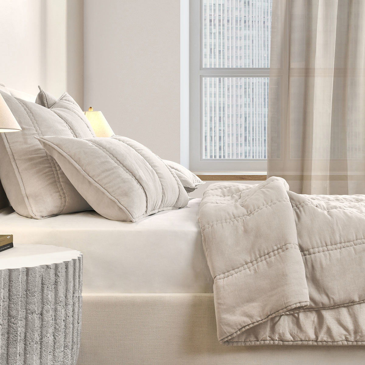 Cream quilt set corner view with quilted throw cover and matching pillows