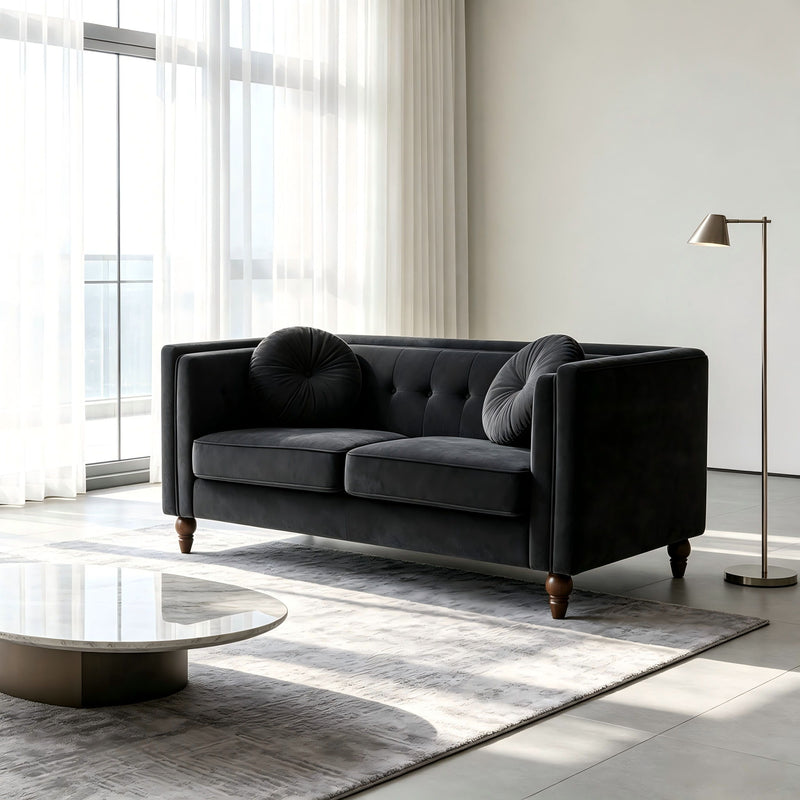 Black tufted two-seater loveseat with rounded back bolster and low arms