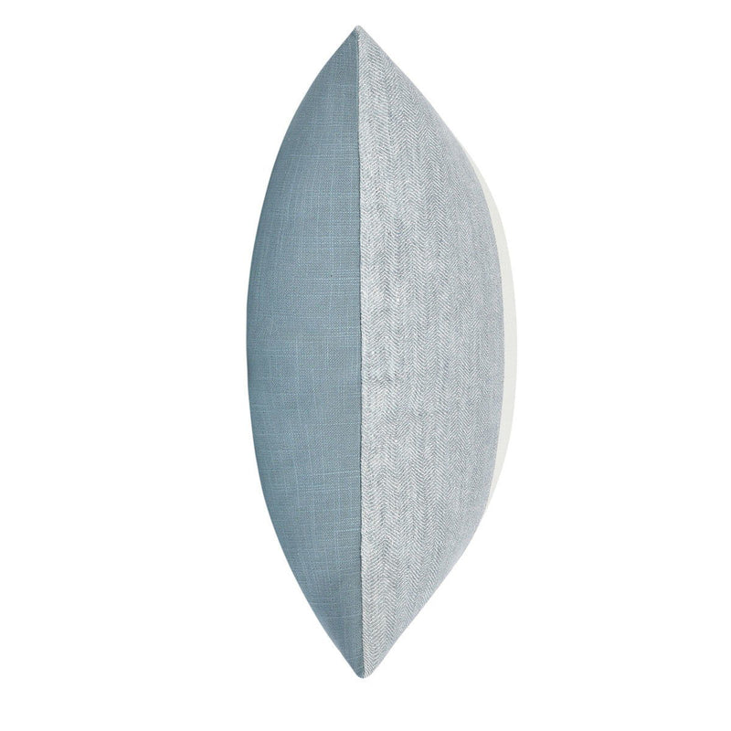 Blue textured throw pillow with stitched edge, narrow side view
