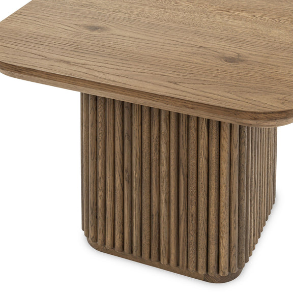 Tawny brown solid wood end table with rounded top and ribbed pedestal column
