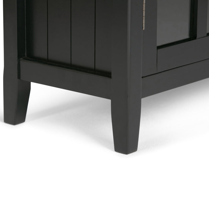 Dark gray cabinet base with four tapered legs and a lower panel under glass doors.