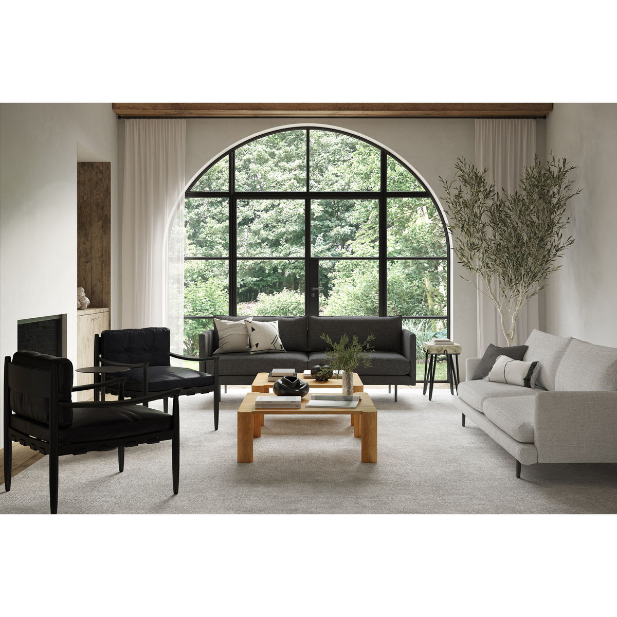 Sand stone accent table with black legs positioned in front of window seating