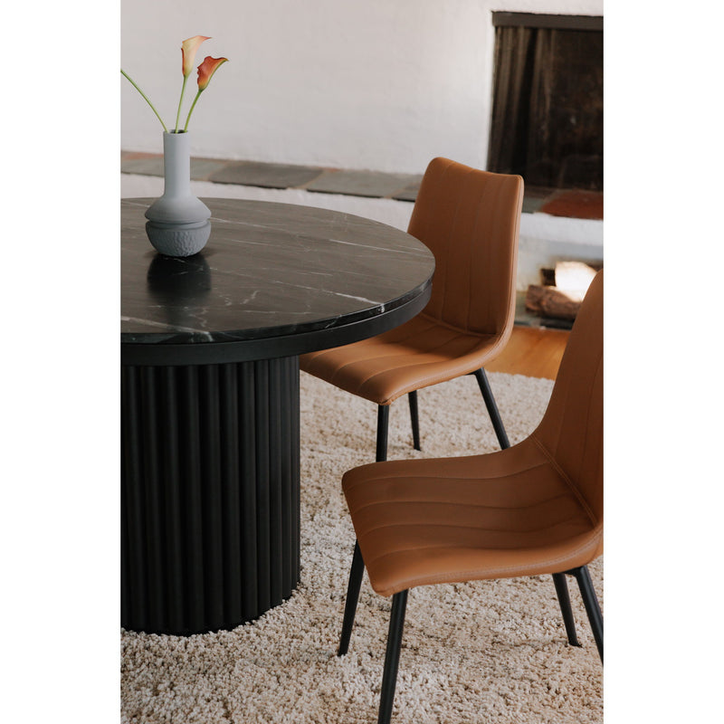 Black round dining table side view with fluted pedestal base and dark stone-look top