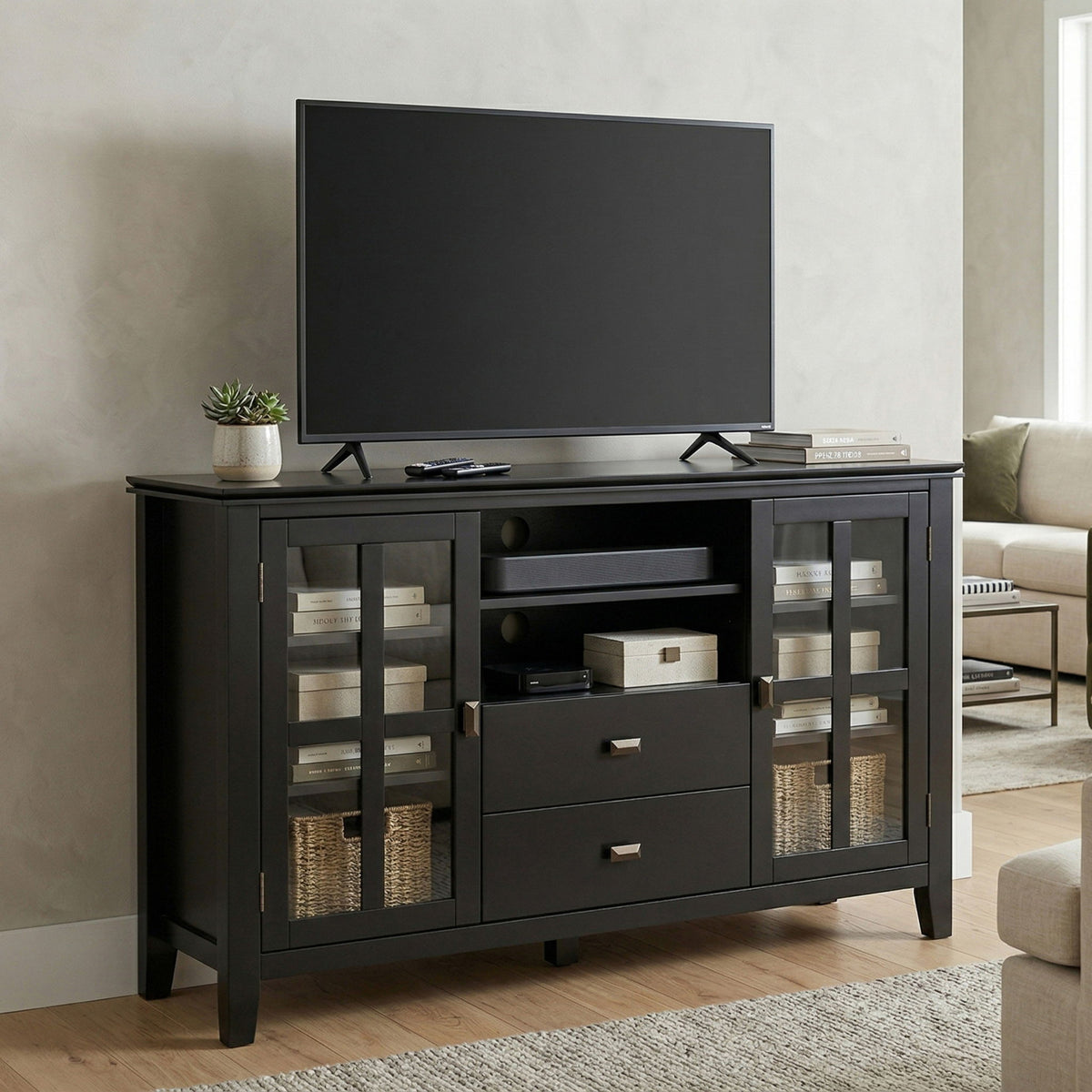 Dark gray TV media stand with center media shelf, two drawers, and glass-panel cabinet doors