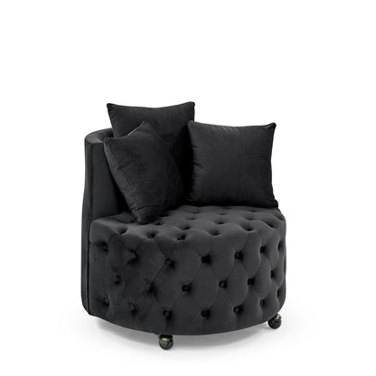Black upholstered swivel chair with button tufting and two throw pillows on caster wheels