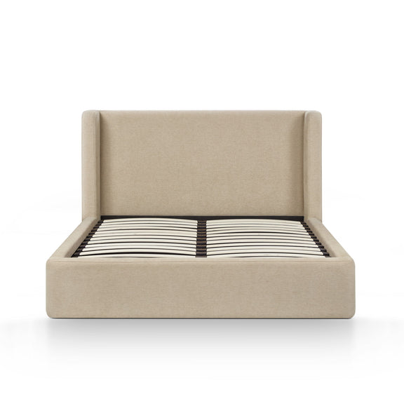 Beige upholstered bed frame with slatted mattress and black-and-white striped cover