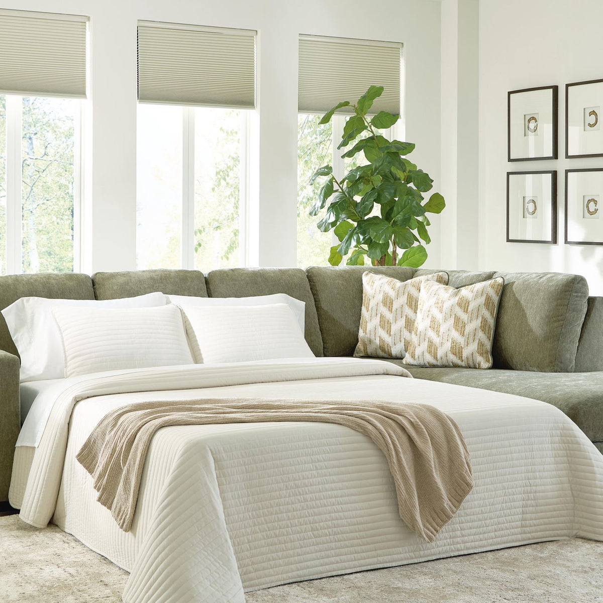 Green sleeper sectional sofa opened into bed with white striped bedding