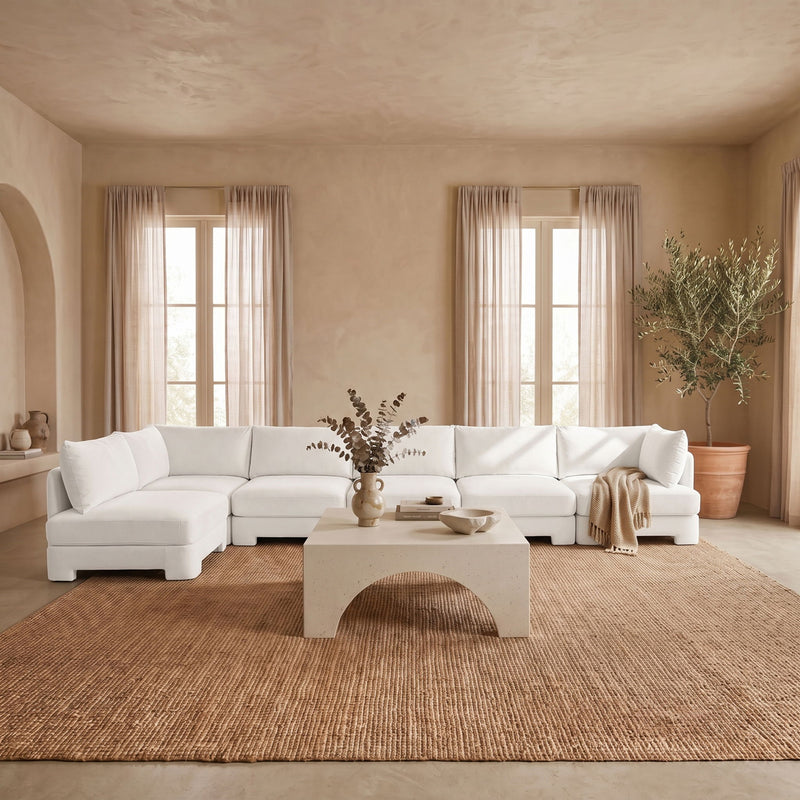 White L-shaped armless sectional sofa with velvet-style upholstery and plush seat cushions