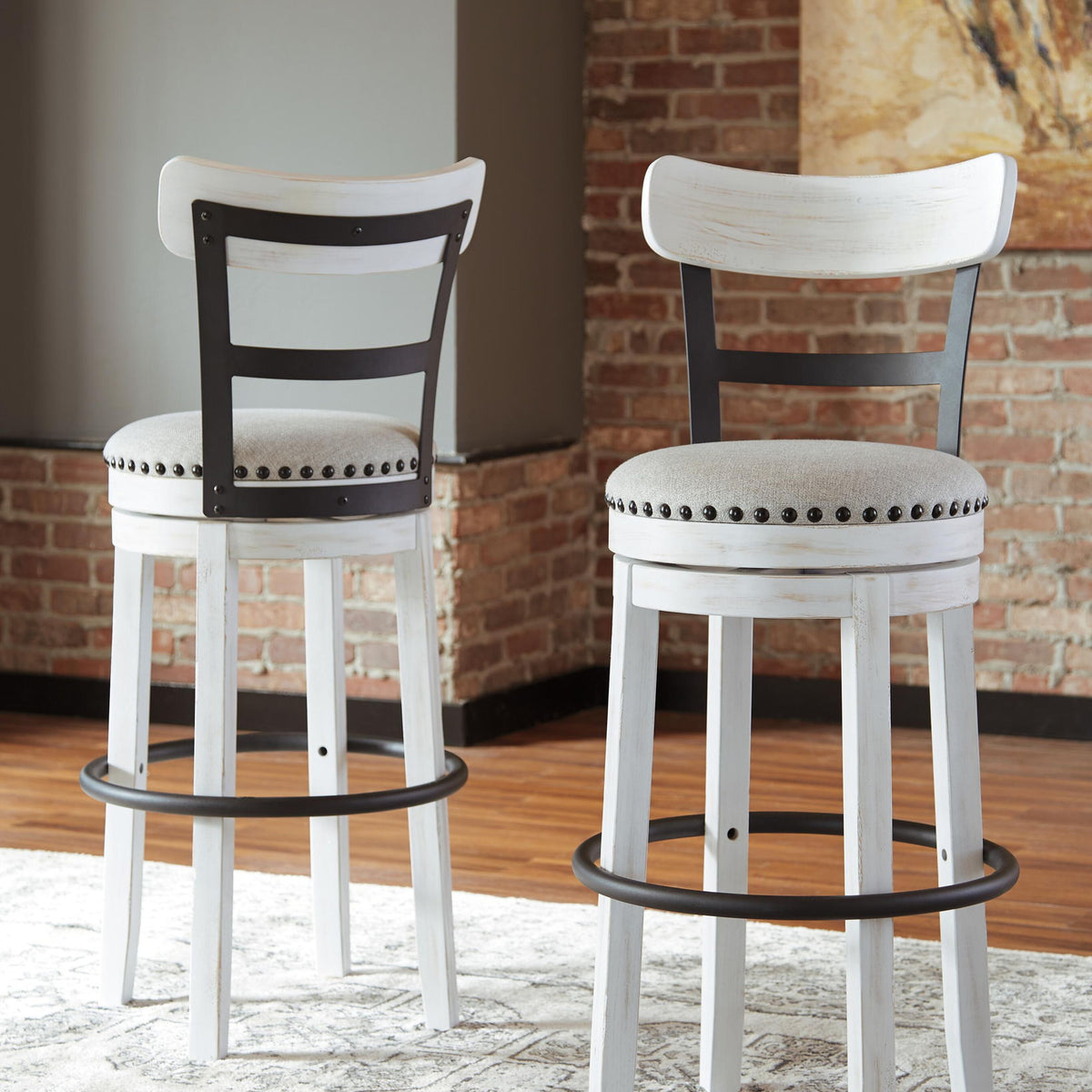 Tall upholstered swivel barstools, white frames with black legs and nailhead seats