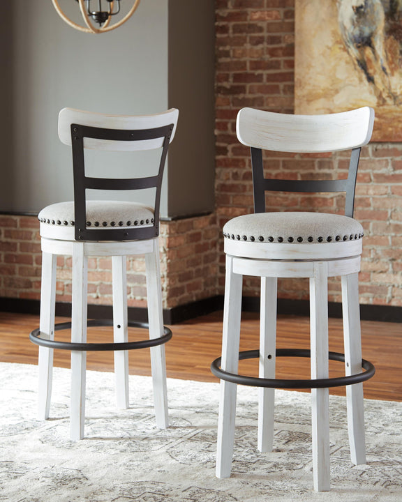 Tall upholstered swivel barstools, white frames with black legs and nailhead seats