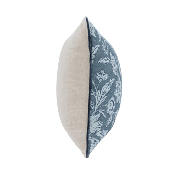 Blue floral accent pillow with solid light backing in side view