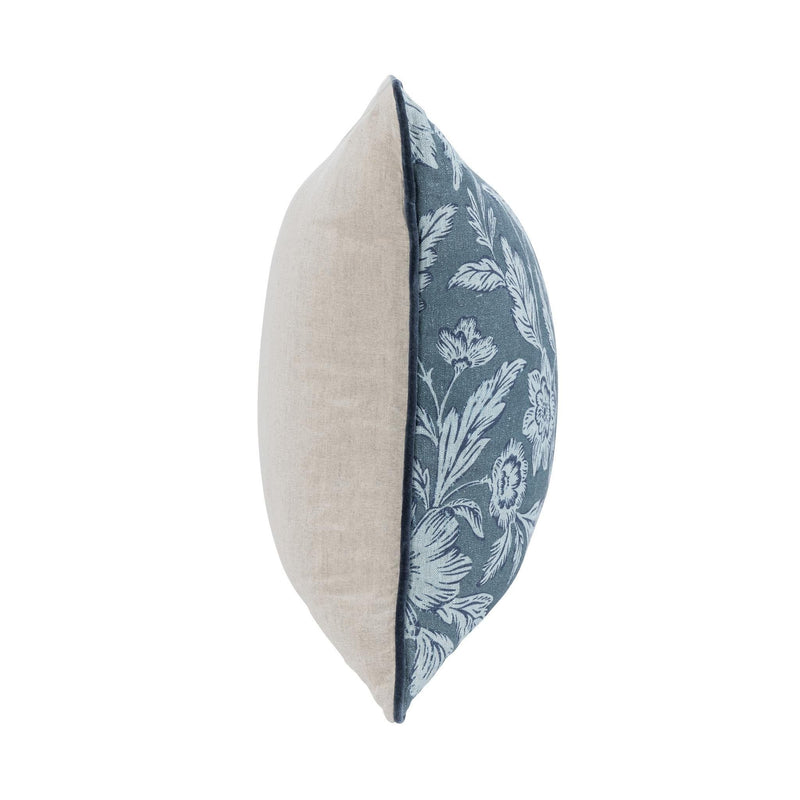 Blue floral accent pillow with solid light backing in side view