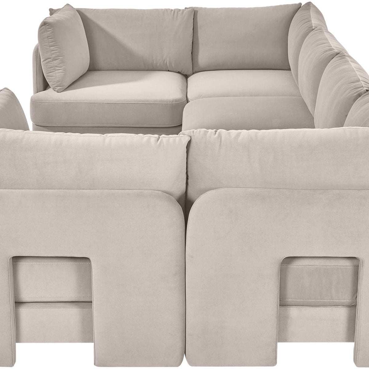 Light gray velvet U-shaped sectional sofa close-up with padded arms and back cushions
