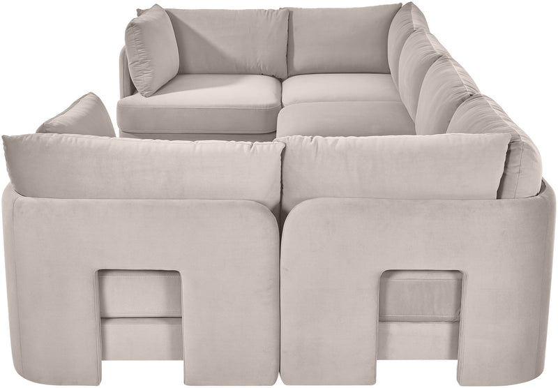 Light gray velvet U-shaped sectional sofa close-up with padded arms and back cushions