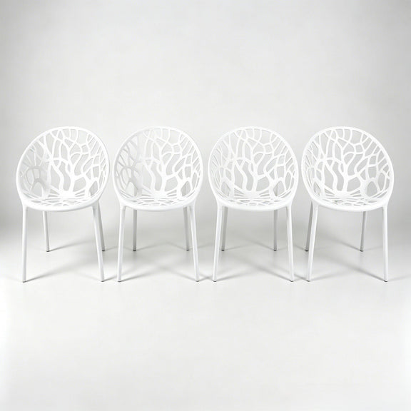 Set of 4 white dining chairs with cutout shell backs and slender legs