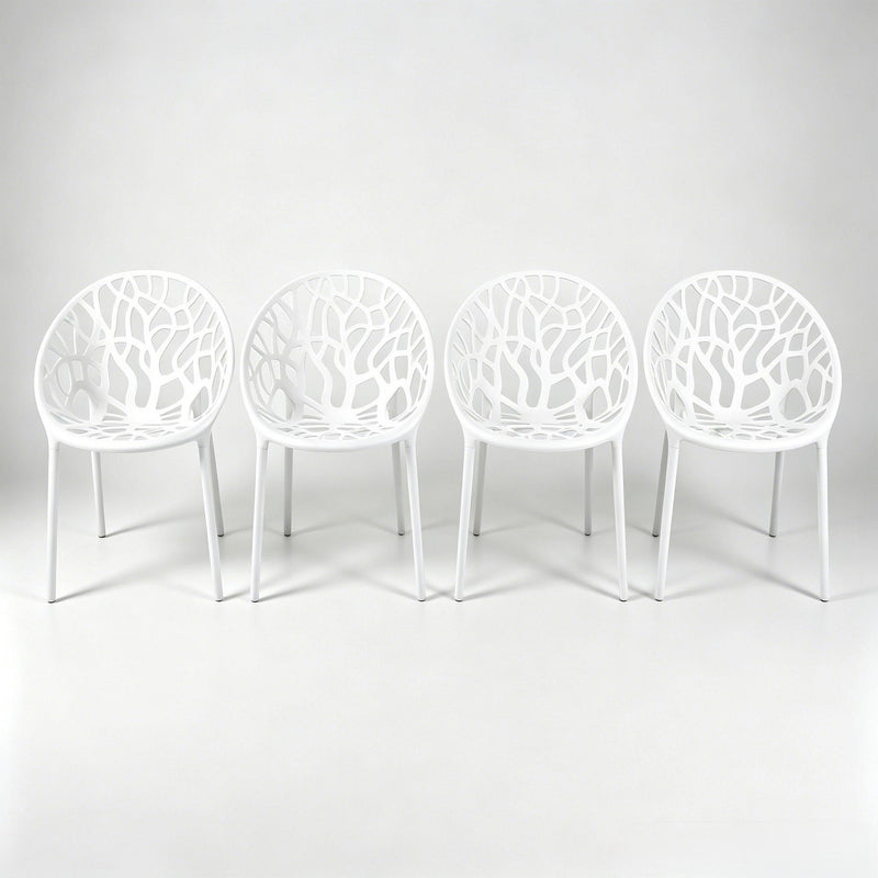 Set of 4 white dining chairs with cutout shell backs and slender legs