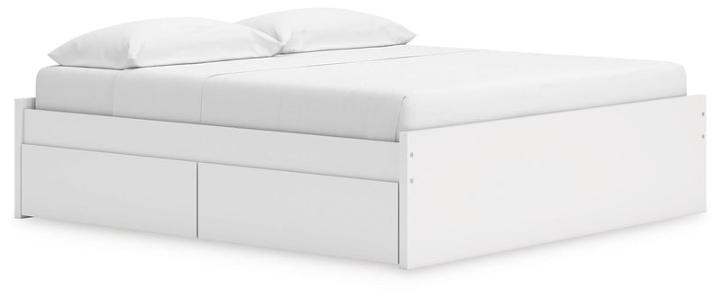 White platform bed with drawer fronts on the front and side