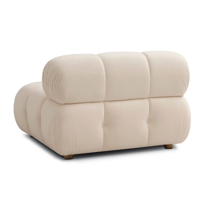 Cream armless modular chair with rounded, tufted cushions and low wooden feet