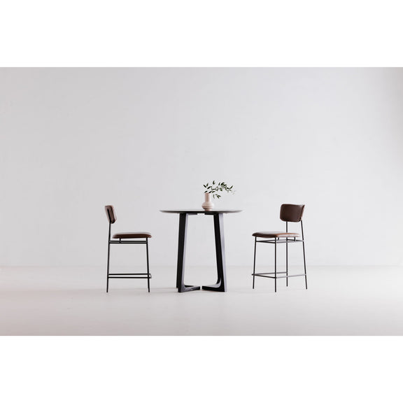 Round black ash counter table with pedestal legs and flat tabletop