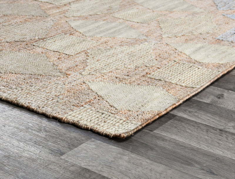 Flatweave rug corner close-up with beige weave and multicolor diamond-thread pattern