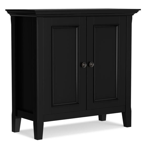 Black two-door low storage cabinet with paneled doors and round metal knob pulls