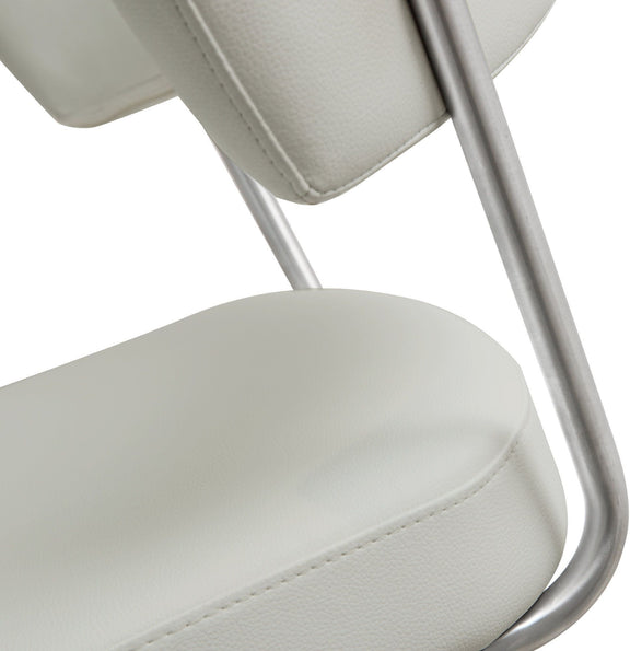 Close-up of light gray/white padded barstool seat with seam stitching and chrome support.
