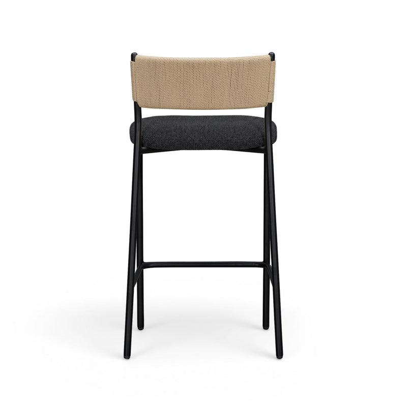 Celine boucle bar stool with beige upholstered back, dark seat, black metal legs.