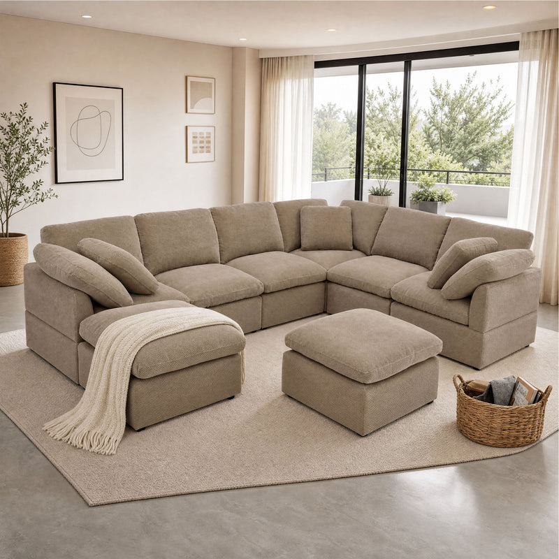 Light brown modular sectional sofa with matching ottoman and two loose cushions.
