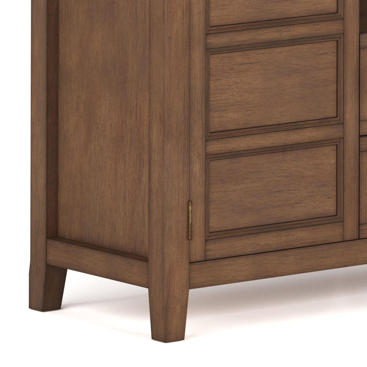 Corner view of tall TV media stand with wood panel doors and vertical cabinet trim