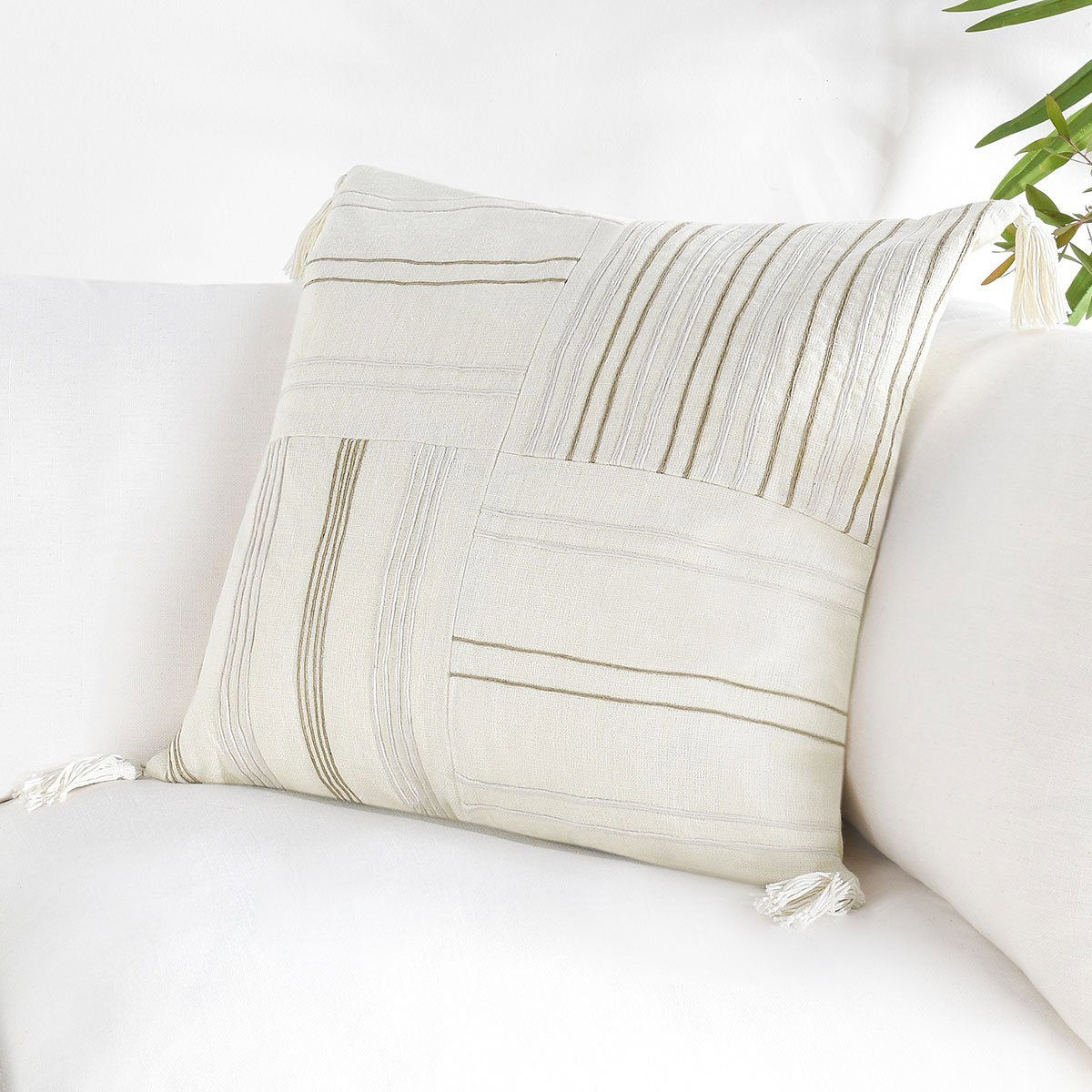 Ivory natural lumbar pillow with stitched stripe panels and corner tassels