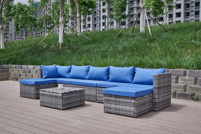 Dark gray patio U-shaped sofa with blue cushions and central coffee table
