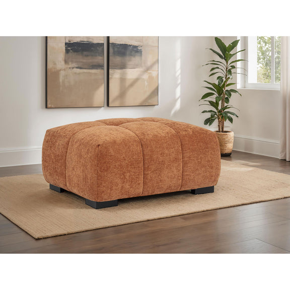 Brown rectangular upholstered ottoman with tufted top and low black legs.