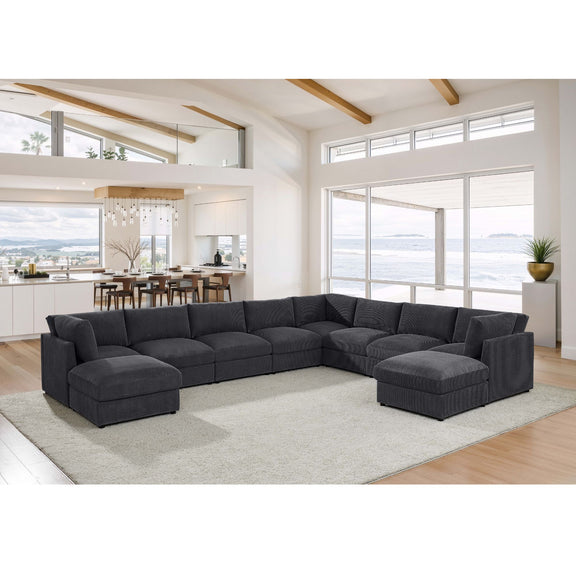 Dark gray modular sectional sofa with two ottomans and wide corner backrest