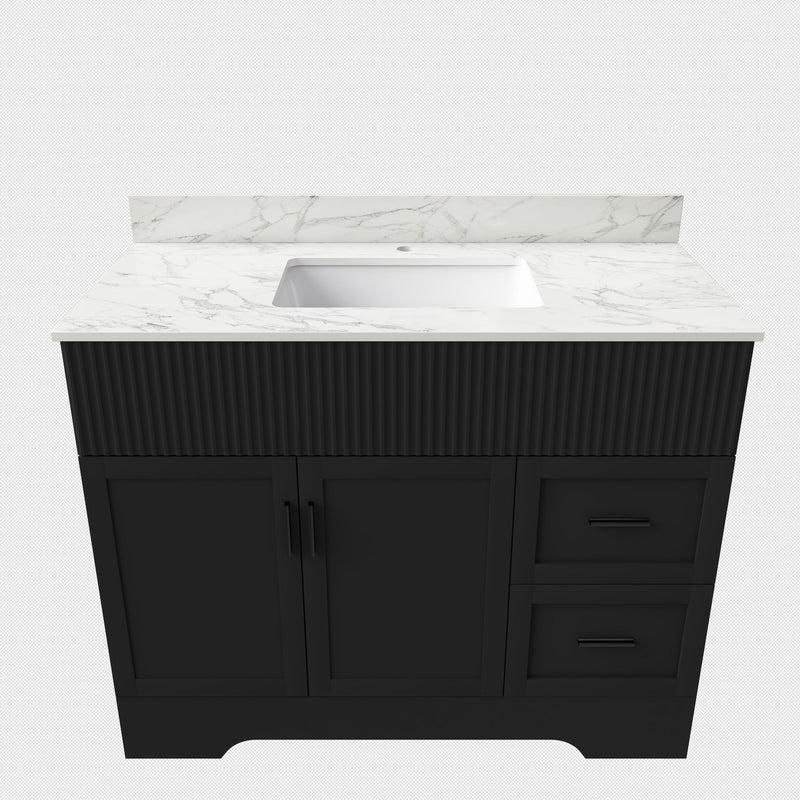 Black bathroom vanity cabinet with fluted doors, drawers, and built-in sink