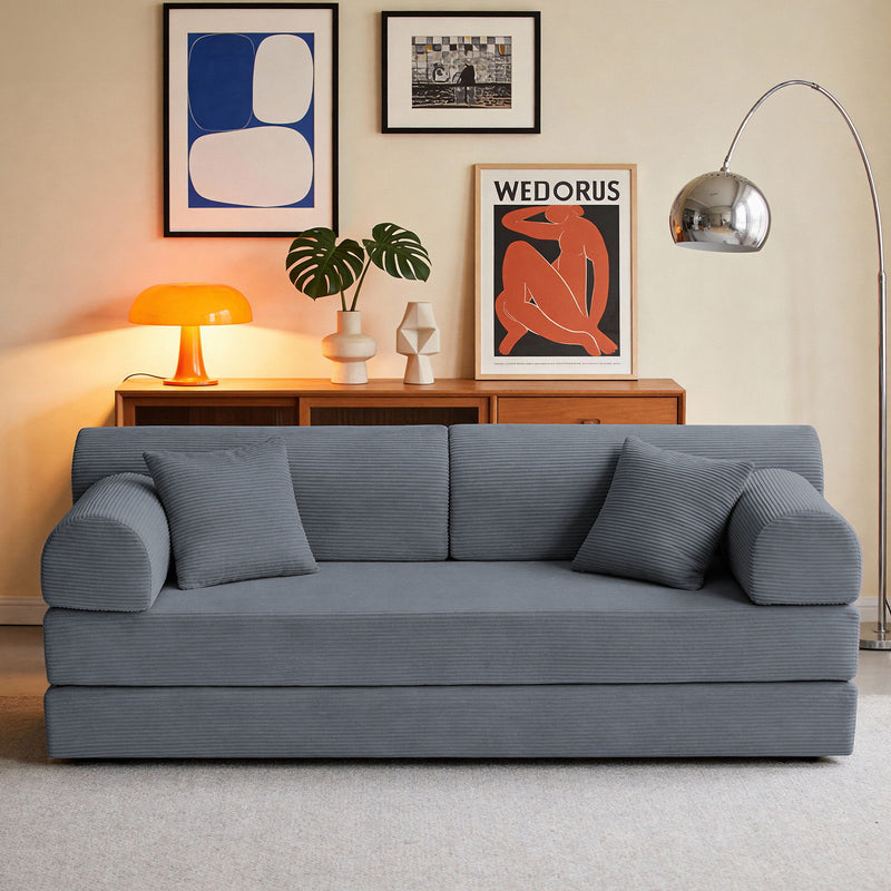 Gray convertible sleeper sofa bed in living room with three seat cushions.