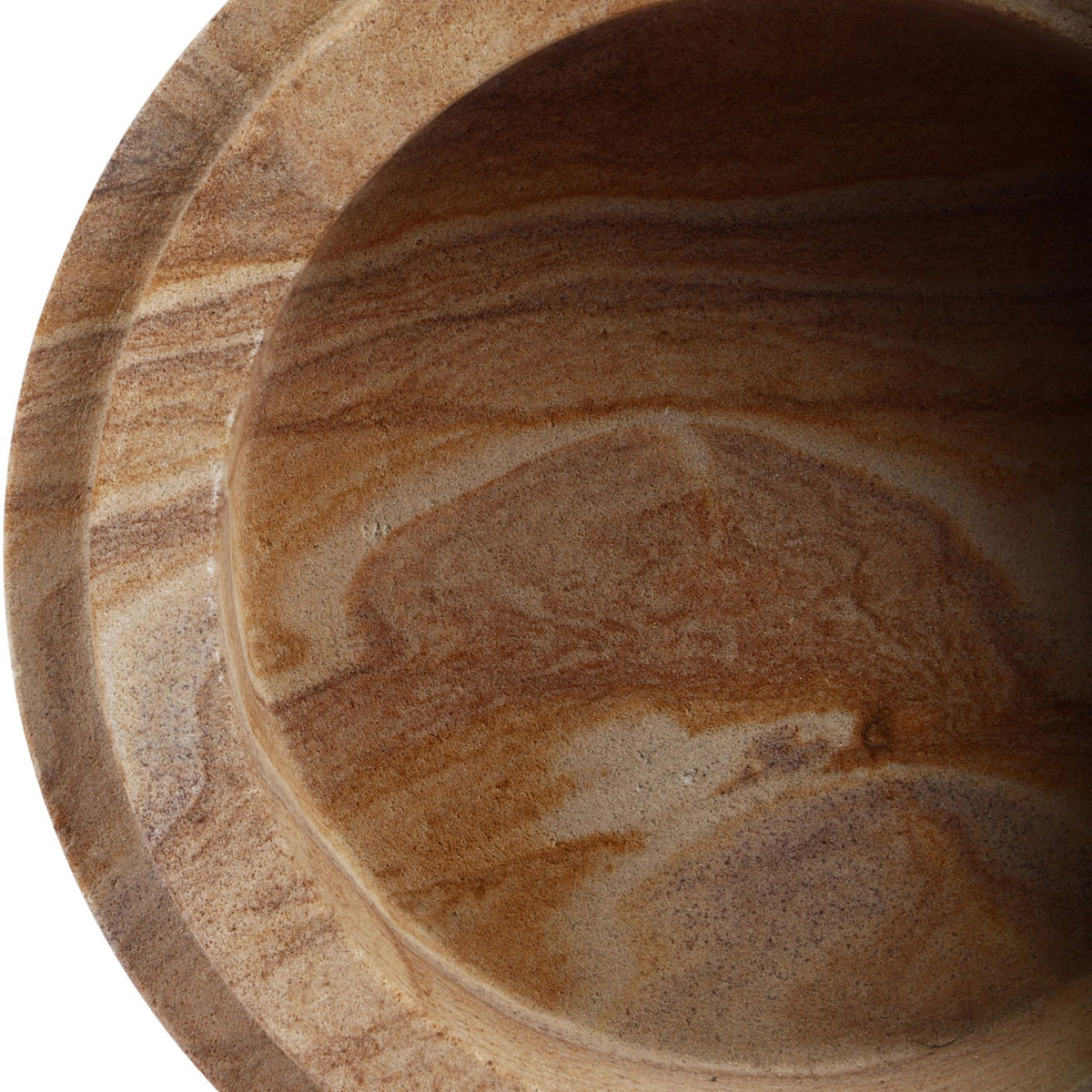 Interior view of light brown sandstone bowl with smooth cavity and stone veining.