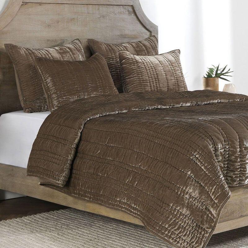 Desert taupe quilt set with textured stitching and four decorative pillows
