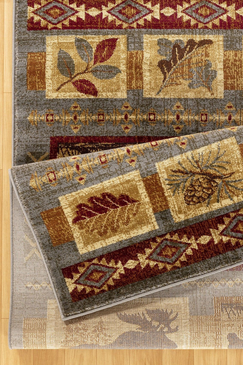 Lodge area rug close-up of animal and floral blocks with burgundy and tan accents