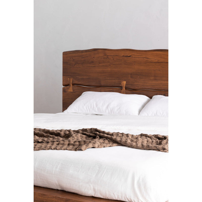 King bed with light brown wood headboard and arched rails, white bedding