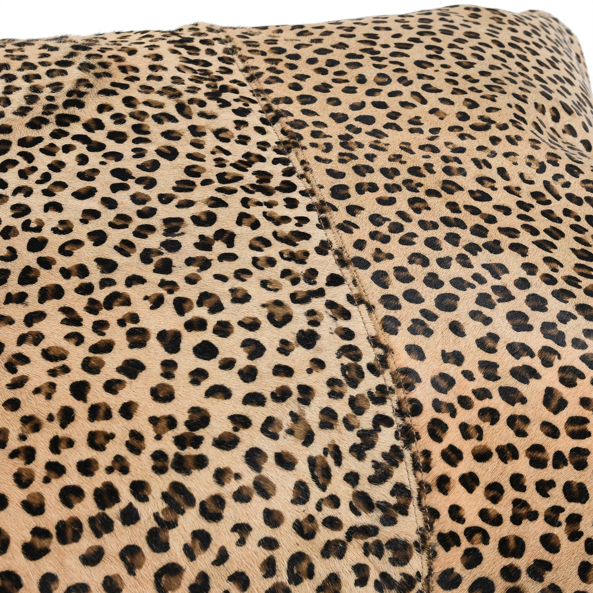 Leopard-print lumbar pillow cover fabric with camel base and black spots, close-up.