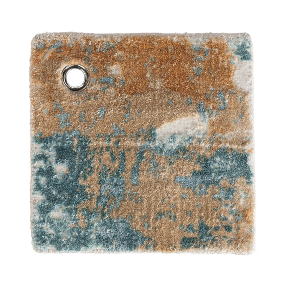 Distressed rug corner close-up with round grommet hole; blue, tan, and rust tones