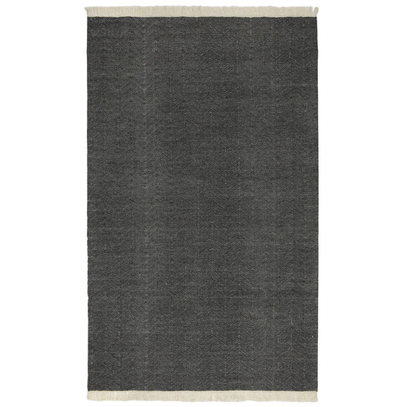 Charcoal indoor/outdoor rug with subtle texture and cream fringe