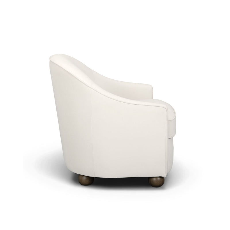 White performance velvet accent chair angled view with rolled arms and short dark legs