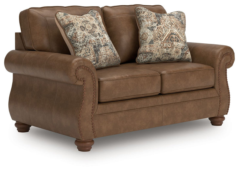 Dark brown loveseat with curved arms and patterned accent pillows, padded seat cushions