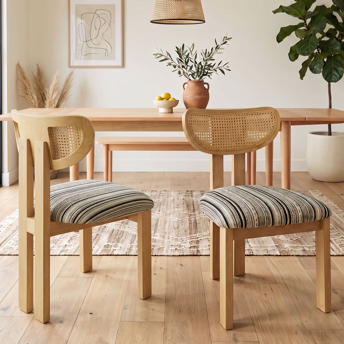 Pair of light brown rattan-back dining chairs with striped upholstered seats