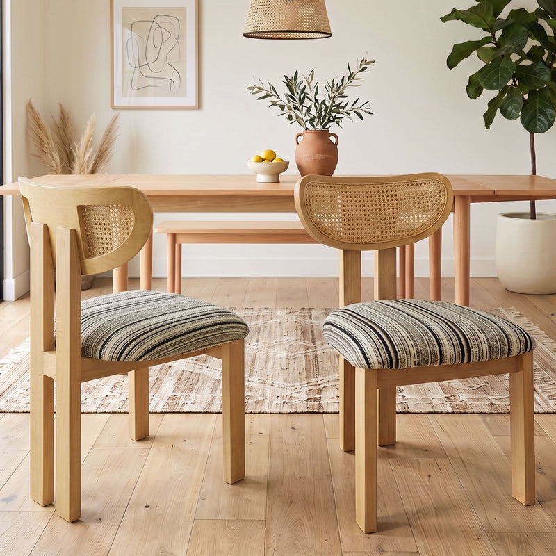 Pair of light brown rattan-back dining chairs with striped upholstered seats
