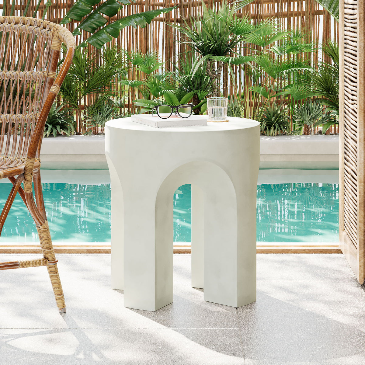 Outdoor accent side table with white round top and arched cutouts
