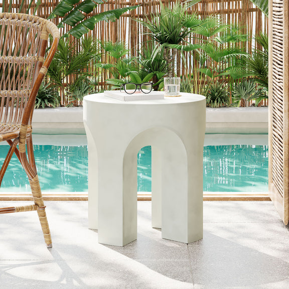 Outdoor accent side table with white round top and arched cutouts