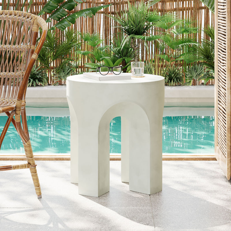 Outdoor accent side table with white round top and arched cutouts